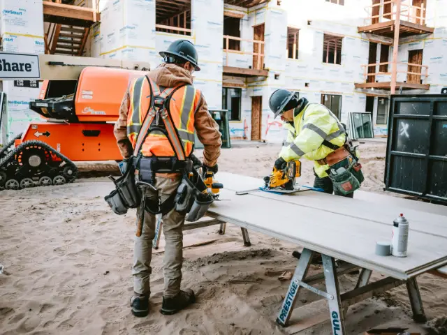 Installers cutting siding on a job site